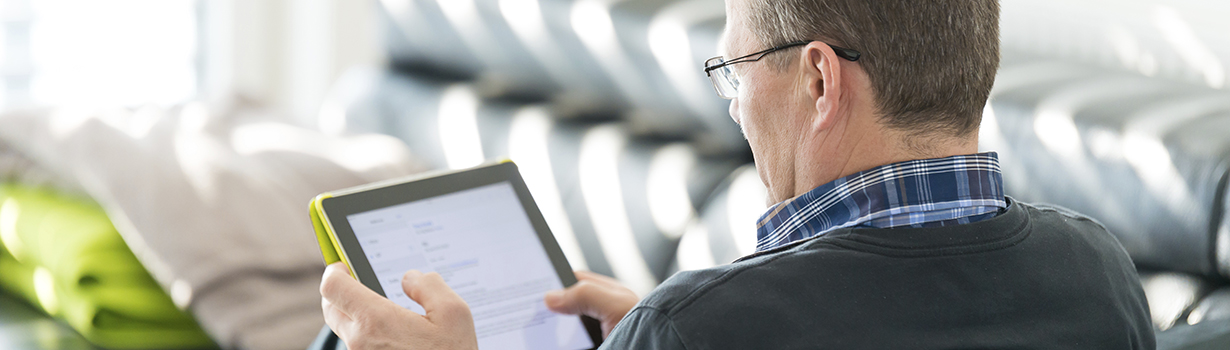 Older man reading on a tablet