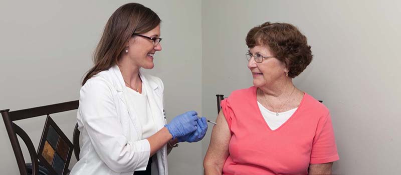 Woman getting an immunization shot at Goody Koontz 